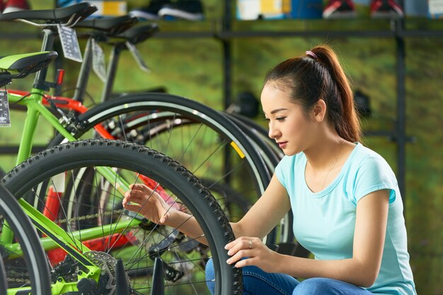 Girl checking wheel spoke