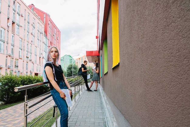 Girl and classmates on background