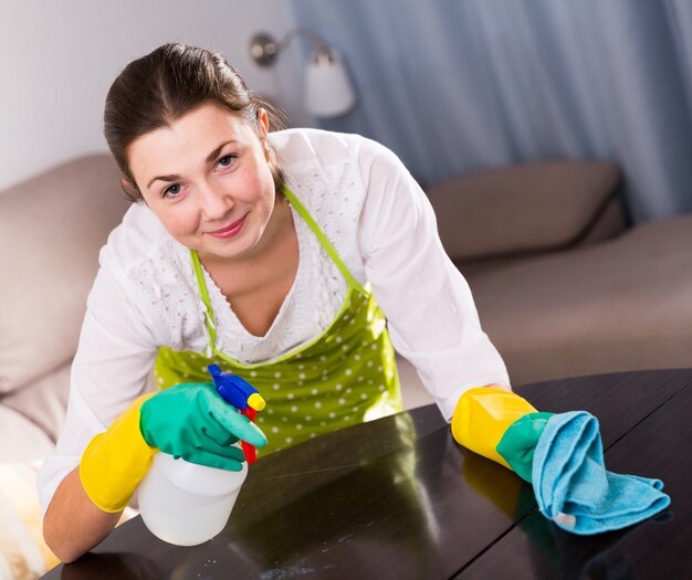 Girl clean table at home