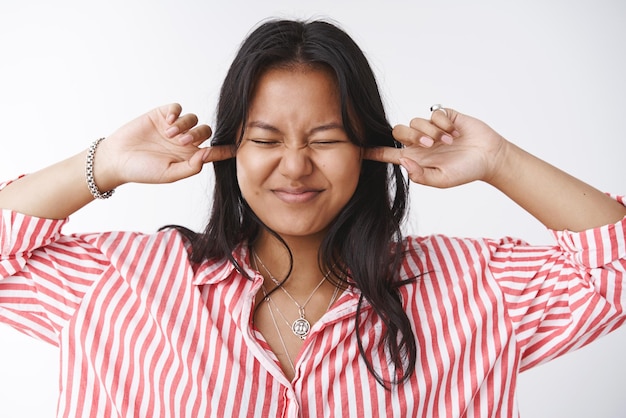 Girl closing ears and eyes smiling