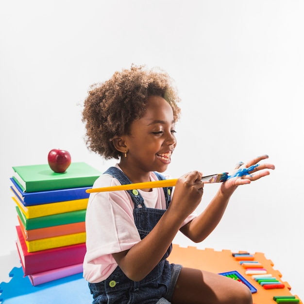 Free photo girl coloring hand with paint in studio