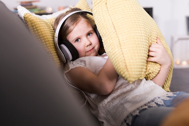 Free photo girl on couch with cushions