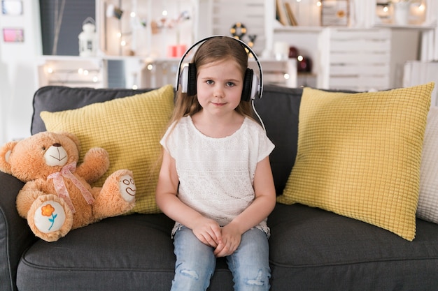 Girl on couch with headphones