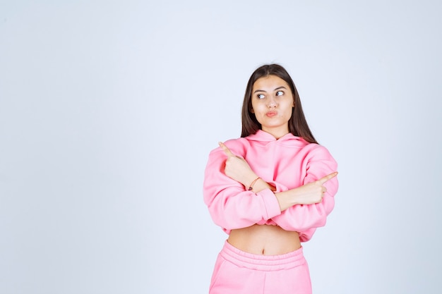 Girl crossing hands and pointing both sides