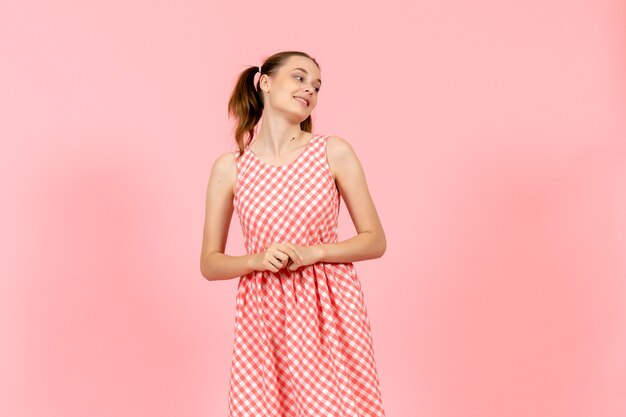 girl in cute bright dress with smiling expression on pink