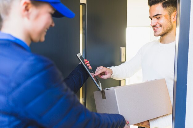 Girl delivering box to young man