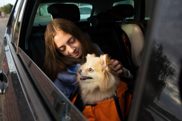 Girl and dog in car medium shot