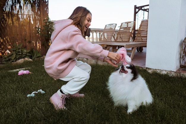 Girl and dog playing outdoors