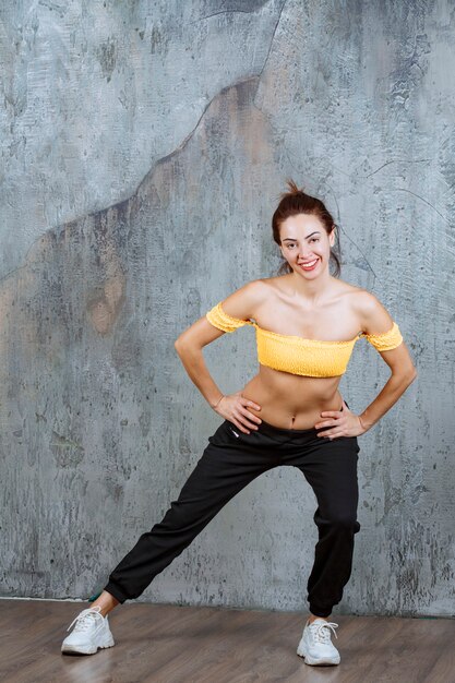 Girl doing back and leg stretching activities on a yoga matte. 