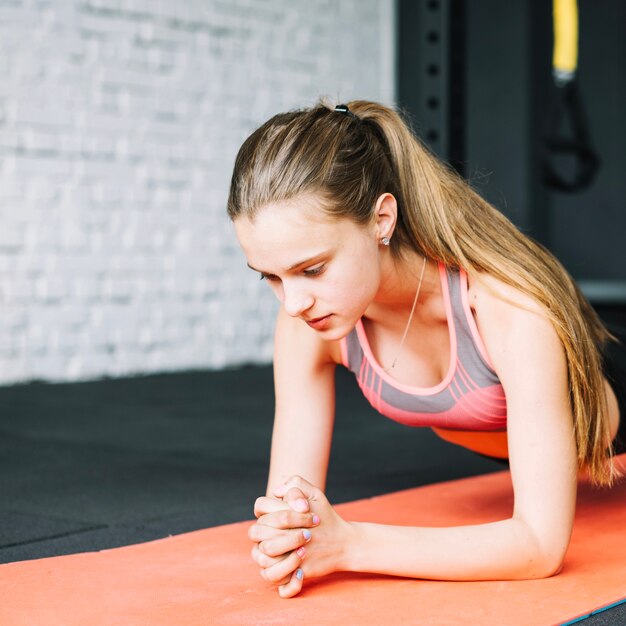 Girl doing exercise on mat