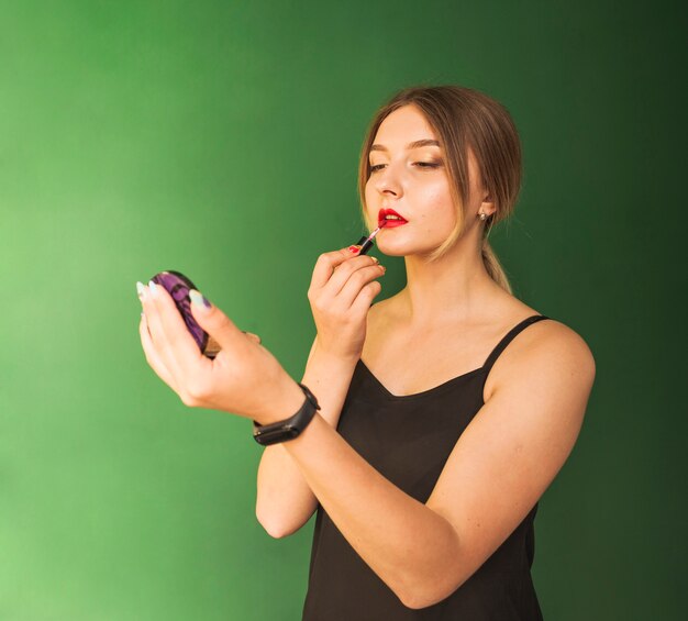 Girl doing her make up in a green room