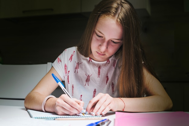 Girl doing homework at table