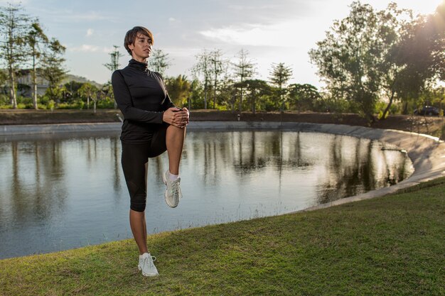 Girl doing warm-up in the park.