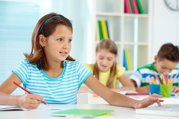 Girl drawing and using a laptop