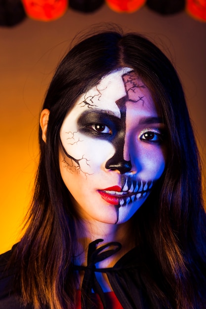 Girl dressed as zombie and wearing mask