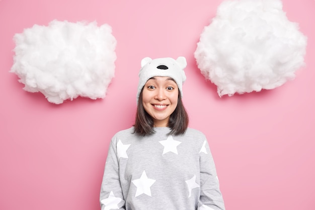 girl dressed in domestic clothes hears positive news isolated on pink