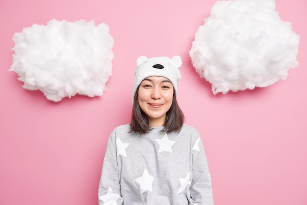 girl dressed in domestic clothes hears positive news isolated on pink