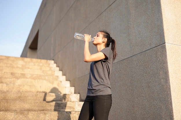 Girl drinking water after exercising