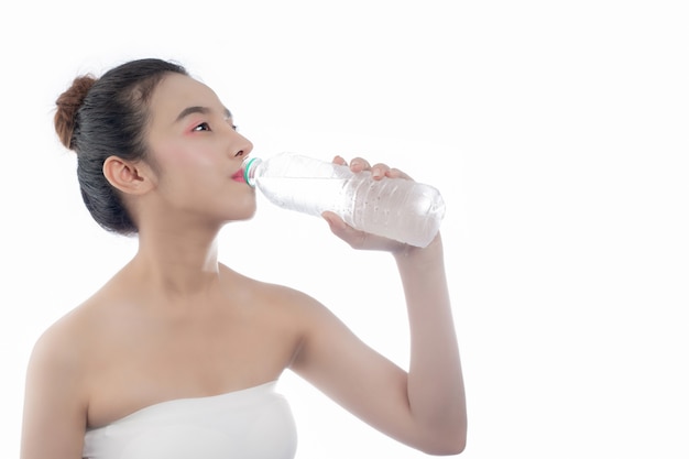 Girl drinking water on a white background.