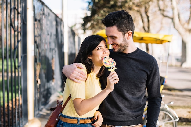 Girl eating lollipop with her boyfriend