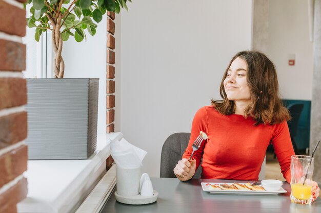 Girl eating in a restaurant