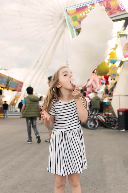 Free photo girl enjoying cotton candy