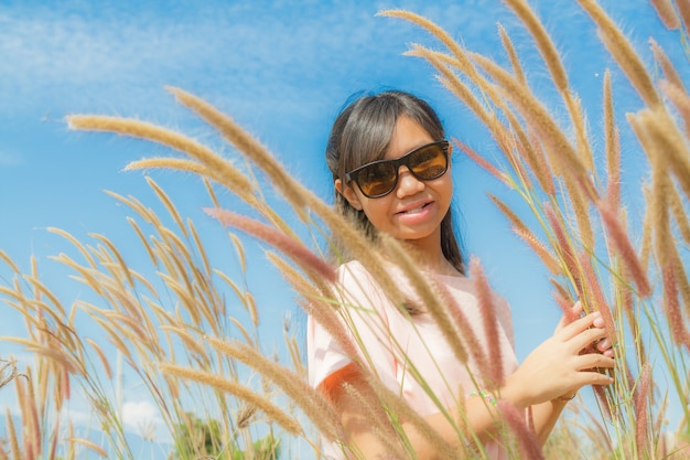 Free photo girl and feather pennisetum