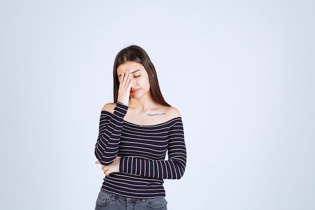 Girl feels exhausted and looks sleepy. 