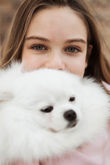 Girl and fluffy dog close-up