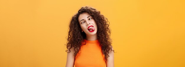 Girl fooling around carefree feeling bored trying amuse herself during boring meeting sticking out t