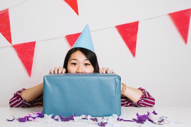 Girl behind gift box