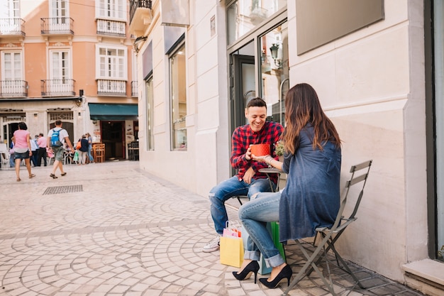 Girl giving boy a a gift