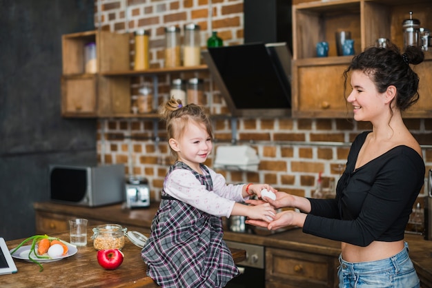 Girl giving eggs to mother