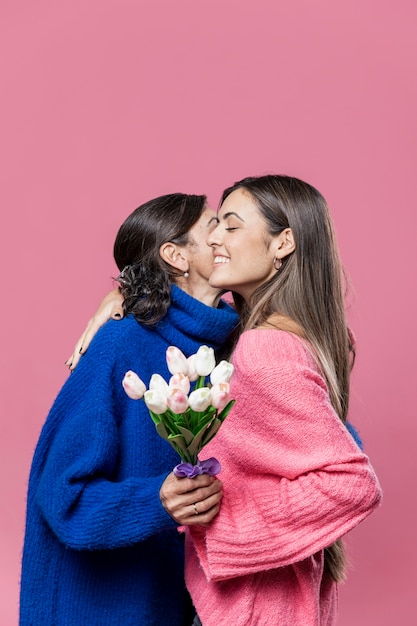 Girl giving flowers to mom