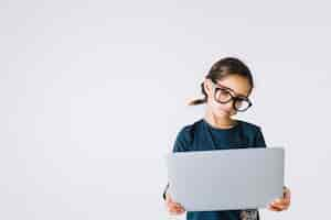 Free photo girl in glasses looking at laptop