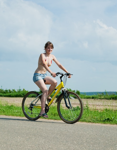Girl goes on bicycle