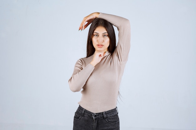 Girl in grey shirt giving positive and appealing poses. 