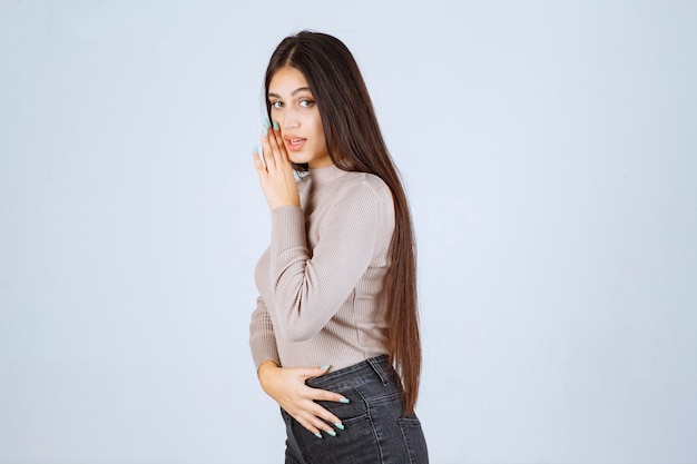 Girl in grey shirt making gossip. 