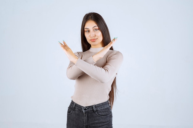 Girl in grey shirt stopping and preventing something. 