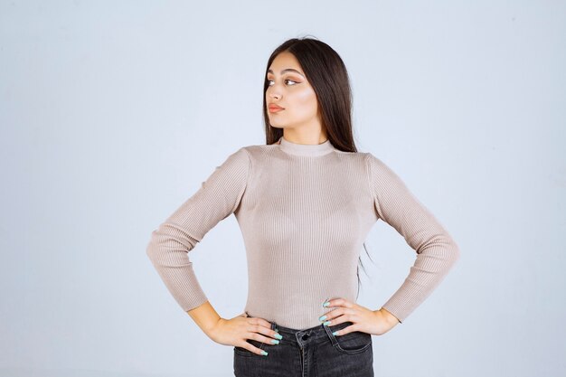 Girl in grey sweater giving nasty and seductive poses. 