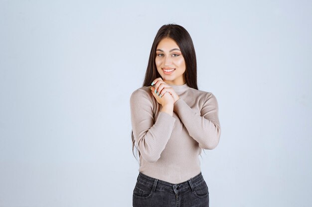 Girl in grey sweater giving nasty and seductive poses.