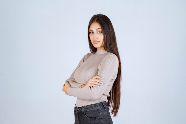 Girl in grey sweater giving nasty and seductive poses.