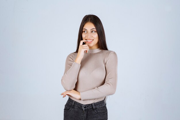 Girl in grey sweater giving nasty and seductive poses.