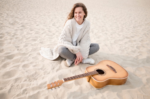 Girl and a guitar on the beach