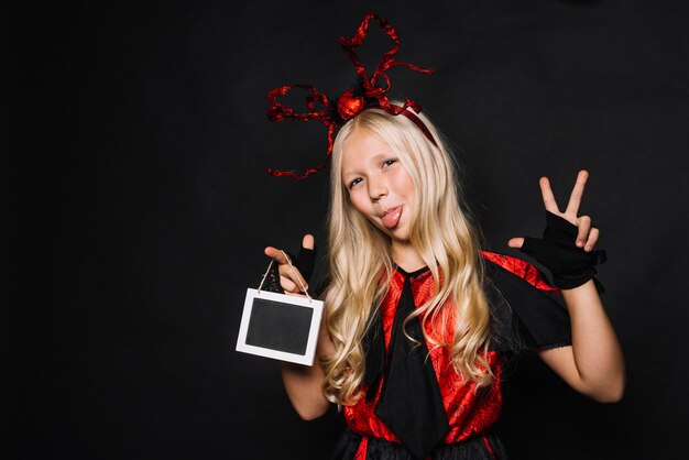 Girl in Halloween costume gesturing and grimacing