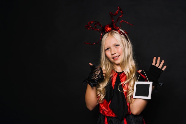 Girl in Halloween costume gesturing thumb-up