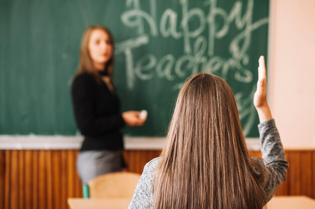 Girl hand up in classroom