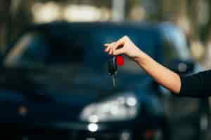 Free photo girl hands with key of new car