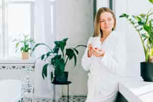 Free photo girl having coffee at the bathroom