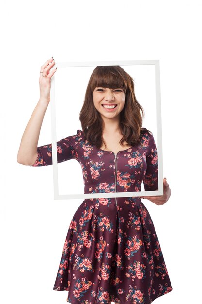 Girl having fun with a white frame